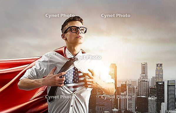 USA Superhero. Young businessman showing American flag under his shirt against sunset city [IBR124944105]