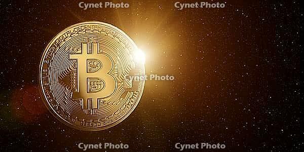 Bitcoin in starry space with rising sun behind [IBR124944106]