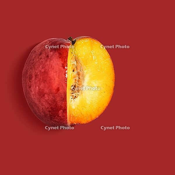 Fresh nectarine on red background, view from above [IBR124944118]