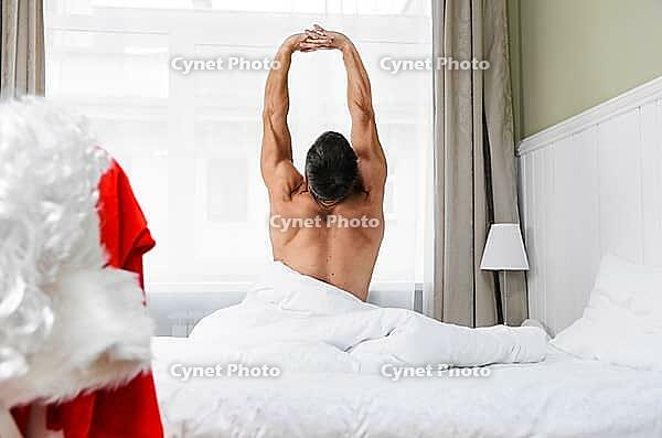 Santa Claus in hotel room without costume getting ready for Christmas or New Year [IBR124944122]