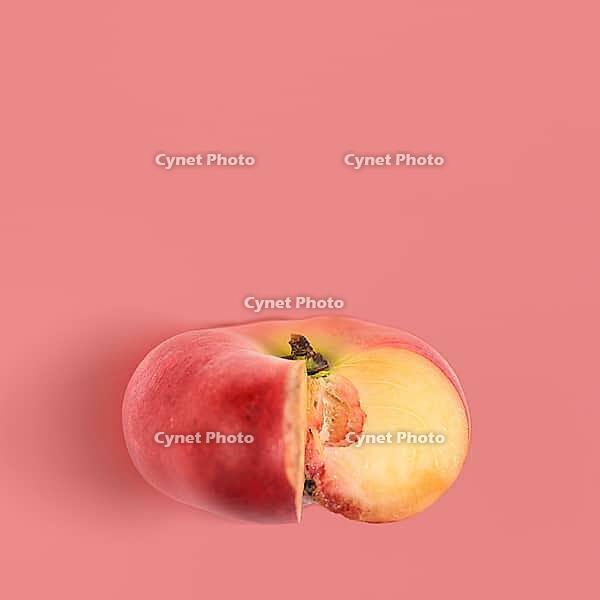 Fresh saturn peach on pink background, view from above [IBR124944128]