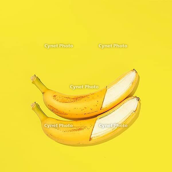 Fresh bananas on yellow background, view from above [IBR124944130]