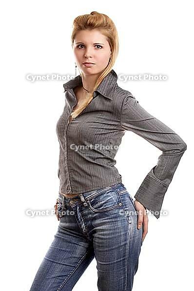 Blonde long-haired girl in shirt and jeans on white background [IBR124968386]