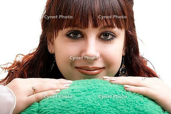 Portrait of brown-haired girl with her lovely toy on white background [IBR124968387]