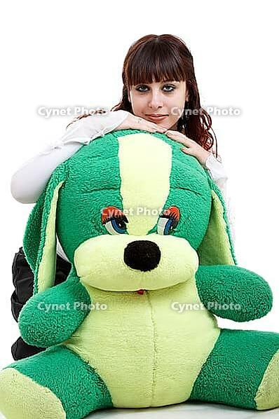 Portrait of brown-haired girl with her lovely toy on white background [IBR124968388]