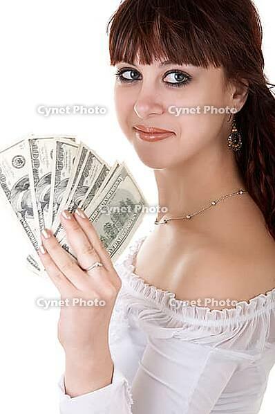 Young brown-haired woman thinking how to spend her money [IBR124968389]