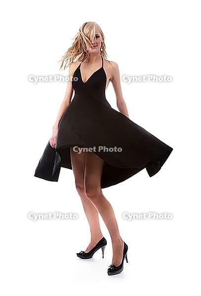 Portrait of beautiful blonde model poses in black dress [IBR124968407]