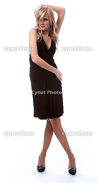 Portrait of beautiful blonde model poses in black dress [IBR124968416]