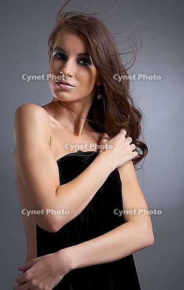 Attractive young model covers her chest with black cloth [IBR124968419]