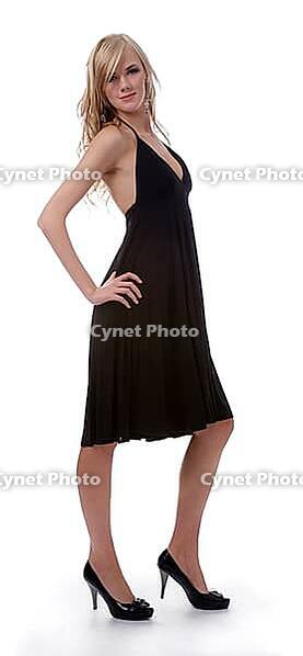 Portrait of beautiful blonde model poses in black dress [IBR124968423]