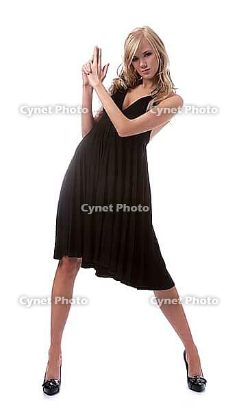 Portrait of beautiful blonde model poses in black dress [IBR124968425]