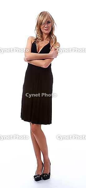Portrait of beautiful blonde model poses in black dress [IBR124968429]