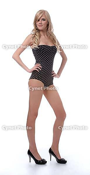 Portrait of beautiful blonde model poses in polka-dot body on white [IBR124968435]