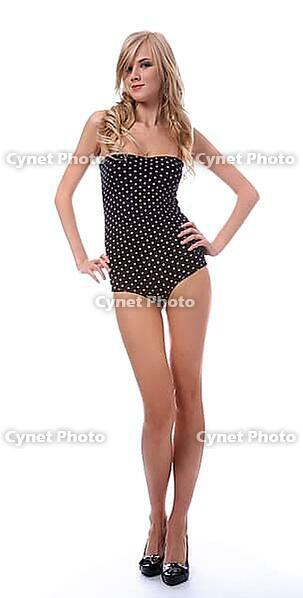 Portrait of beautiful blonde model poses in polka-dot body on white [IBR124968436]