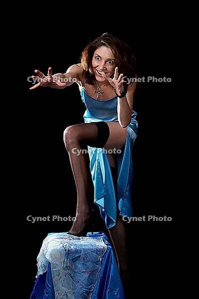 Woman in blue peignoir and tights isolated on the black background [IBR124968440]