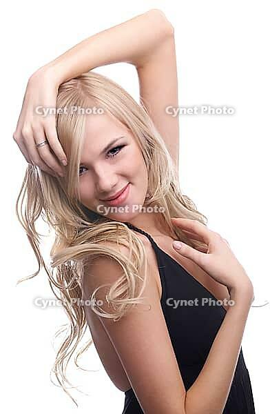 Close-up portrait of beautiful sensual blonde model poses looking over her shoulder and slightly touches her hair [IBR124968446]