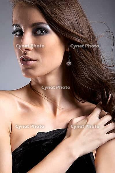 Attractive young model covers her chest with black cloth [IBR124968448]