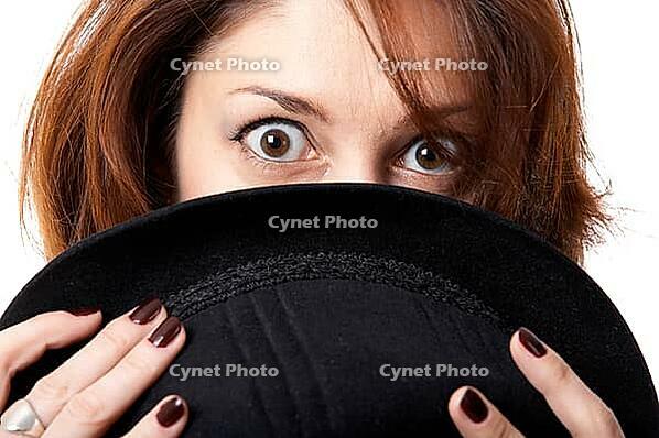 Young woman with hat isolated on the black background [IBR124968451]