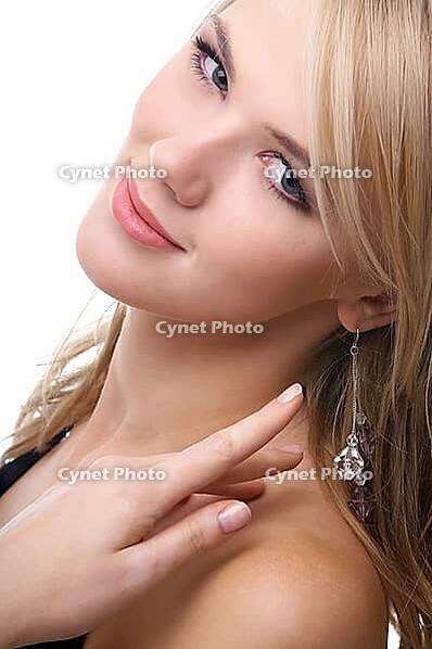 Close-up portrait of beautiful sensual blonde model poses looking over her shoulder and slightly touches her hair [IBR124968458]