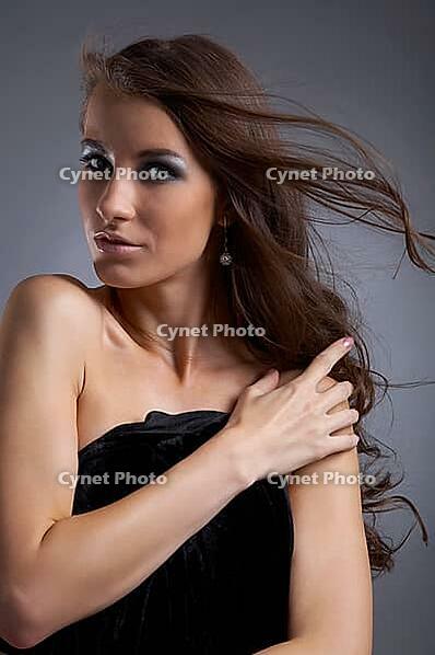 Attractive young model covers her chest with black cloth [IBR124968459]