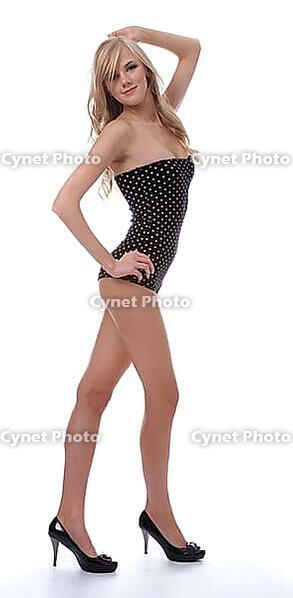 Portrait of beautiful blonde model poses in polka-dot body on white [IBR124968461]
