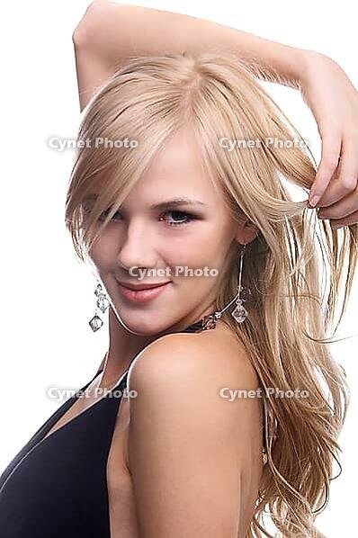Close-up portrait of beautiful sensual blonde model poses looking over her shoulder and slightly touches her hair [IBR124968470]