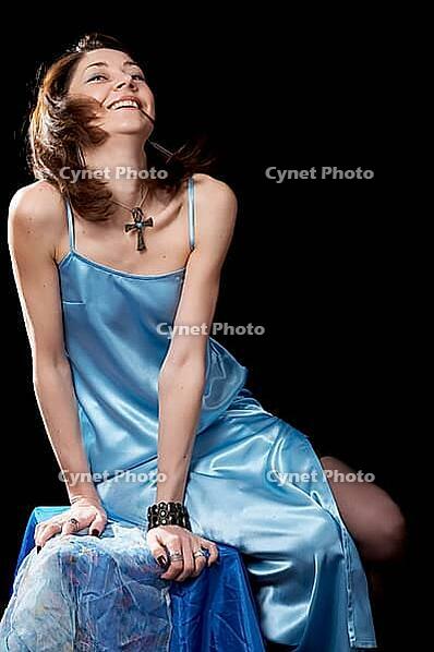 Woman in blue peignoir and tights isolated on the black background [IBR124968475]
