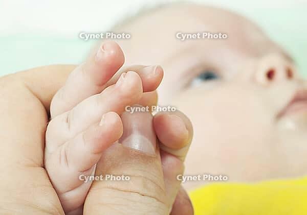 The hand of the child gently lays [IBR124991079]
