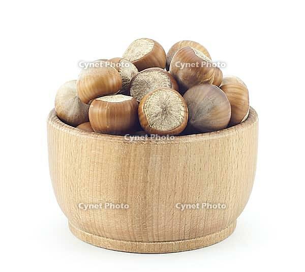 Ripe hazelnuts wooden saucer on a white background [IBR124991127]