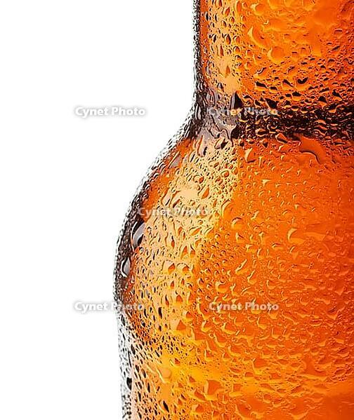Bottle of beer with drops on white background [IBR124991141]