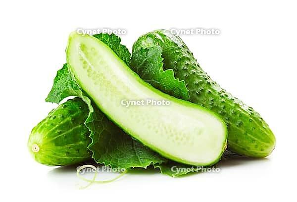 Heap of fresh green cucumbers with leaf and yellow flowers. Placed on white background. Close-up [IBR124991164]