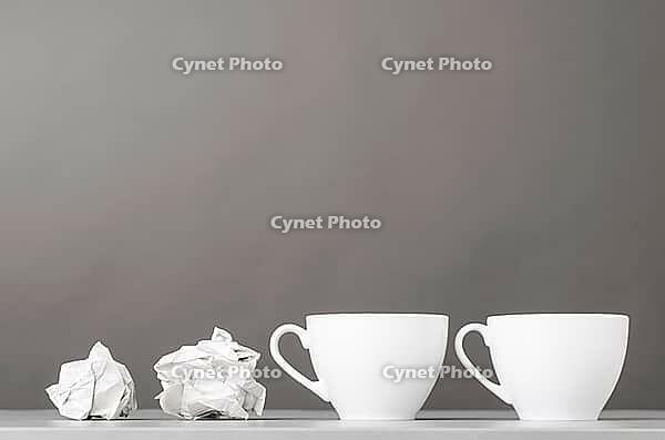 Creative process. crumpled wads and cup on gray [IBR125000237]