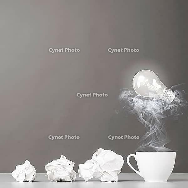 Creative process. crumpled wads and cup on gray [IBR125000238]