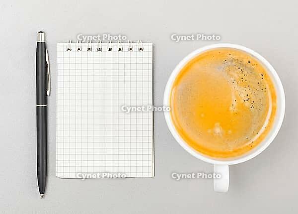 Creative process. blank notebook and cup on gray [IBR125000240]