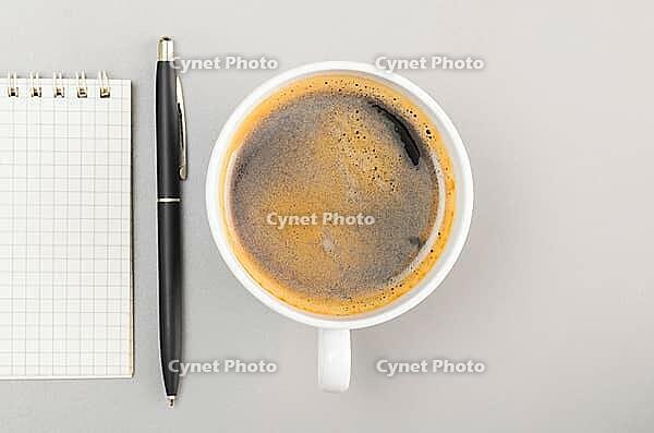 Creative process. blank notebook and cup on gray [IBR125000241]