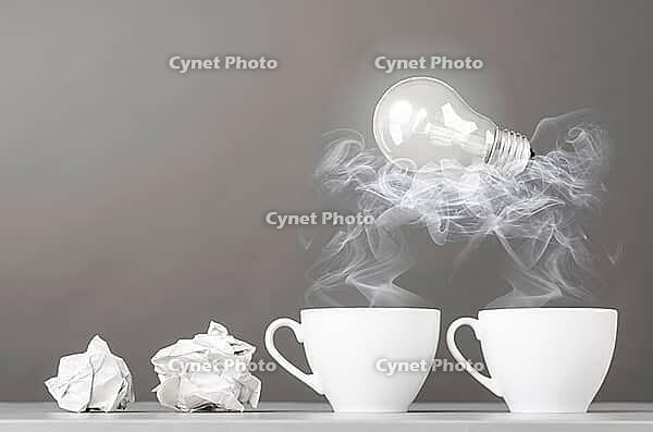 Creative process. crumpled wads and cup on gray [IBR125000242]