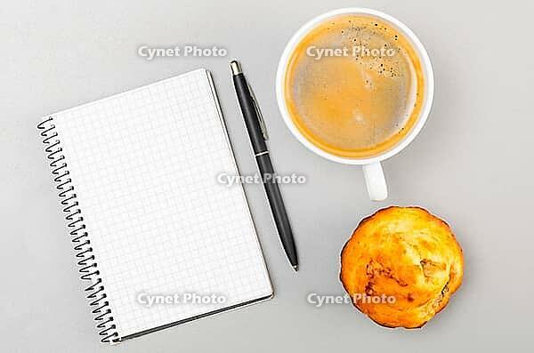 Creative process. blank notebook and cup on gray [IBR125000246]