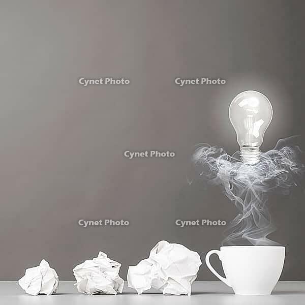 Creative process. crumpled wads and cup on gray [IBR125000247]
