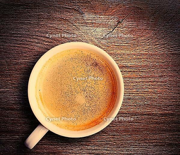 Cup of fresh espresso on table, view from above [IBR125000251]