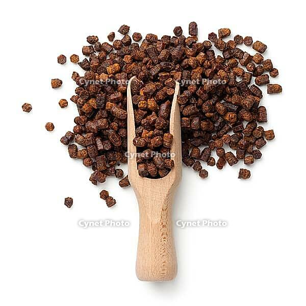 Bee pollen propolis in wooden scoop isolated on white background. Top view [IBR125000257]