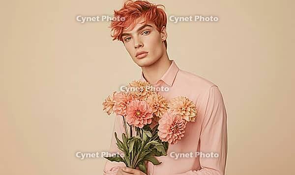 A portrait of a young man with coral-colored hair, holding a bouquet of coral dahlias at his side. AI generated [IBR125000265]