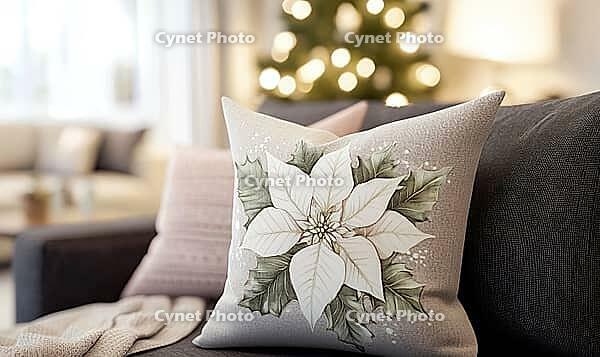 Warm taupe pillow with a detailed white poinsettia print and pale pink accents. AI generated [IBR125000294]