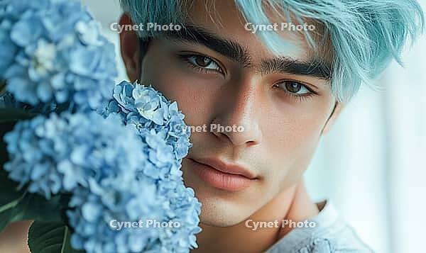 Closeup portrait of a young man with sea-blue hair, holding blue hydrangeas. AI generated [IBR125000314]