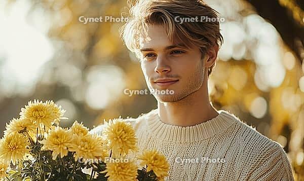 Closeup portrait of a man with sandy blonde hair, holding yellow chrysanthemums. AI generated [IBR125000318]