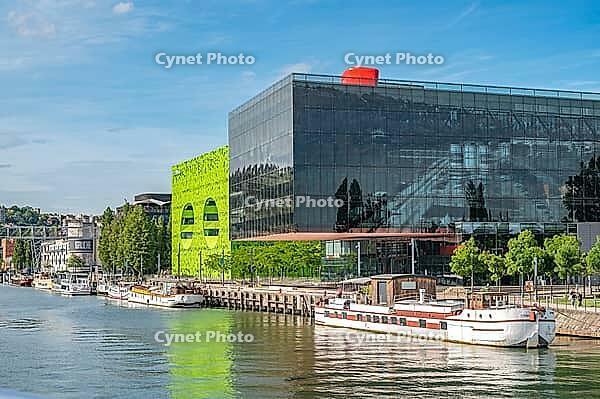 Modern, contemporary architecture on the banks of the Saone Quai Rambaud with Pavilion 8 designed by Odile Decq and the eye-catching green Cube Vert by Dominique Jakob and Brendan MacFarlane and moored Peniche barges in the revitalized La Confluence harbo [IBR125002334]