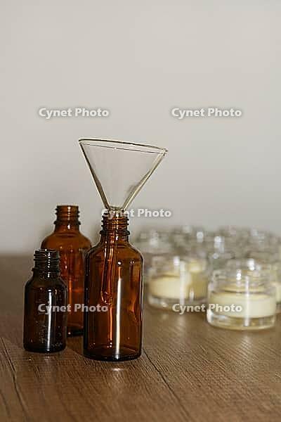 Dark glass bottles with glass funnel, in the background glasses with homemade cream, Kempen, Viersen district, North Rhine-Westphalia, Germany [IBR125007622]