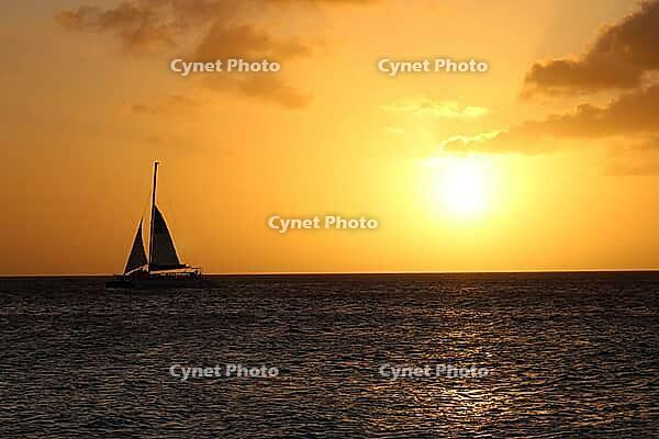 A majestic sunset sailing scene over the ocean. Golden idyllic Aruba vacation landscape.Tranquil peaceful backdrop [IBR125026131]