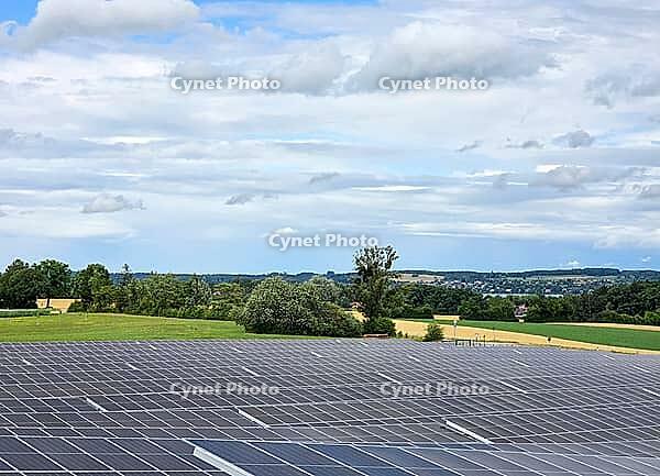 Clouds move over solar field in sunny skies, photovoltaic system on Lake Lake Ammer, Bavaria, Germany [IBR125030429]