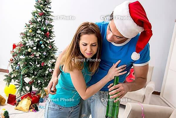 Young family celebrating christmas at home [IBR125053206]