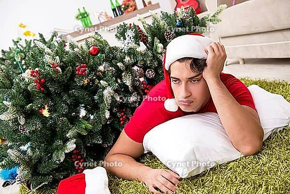 Young man drunk at home after christmas party [IBR125053208]